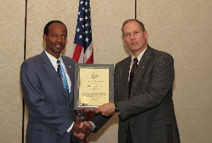 Chapter Vice President Wells Barlow (r) presents the chapter's Distinguished Lifetime Member Award to Jerry Sirmans, chapter vice president for military affairs, at the April luncheon.